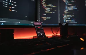 Web development setup with computers and a smartphone.