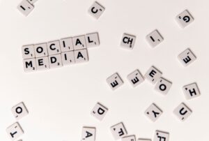 Scrabble tiles spelling 'Social Media' on a white background, symbolizing digital communication.